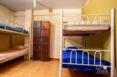 a bunk bed room with two bunk beds at Manuel Antonio Hostel in Manuel Antonio