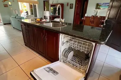 a dishwasher with its door open in a kitchen at Villa Almería by Vacation Pura Vida in Bejuco