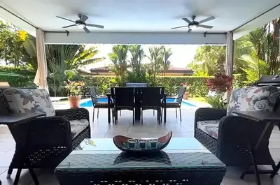 a screened in patio with a table and chairs at Villa Almería by Vacation Pura Vida in Bejuco
