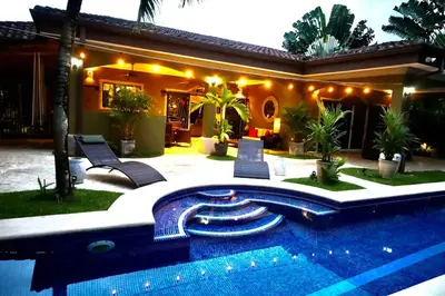 a house with a swimming pool in front of a house at Villa Encantada by Vacation Pura Vida in Esterillos