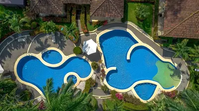 an overhead view of a swimming pool at a resort at Villa Encantada by Vacation Pura Vida in Esterillos