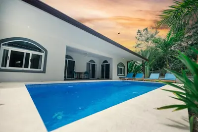 a swimming pool in the backyard of a house at Villa Isabella by Vacation Pura Vida in Esterillos