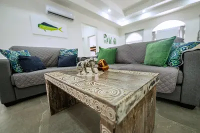 a living room with a couch and a coffee table at Villa Isabella by Vacation Pura Vida in Esterillos