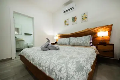 a bedroom with a bed with a stuffed animal on it at Villa Isabella by Vacation Pura Vida in Esterillos
