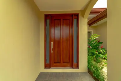a wooden door on the side of a house at Villa Jardin by Vacation Pura Vida in Esterillos
