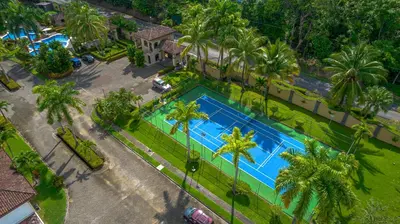 an overhead view of a swimming pool with palm trees at Villa Jardin by Vacation Pura Vida in Esterillos