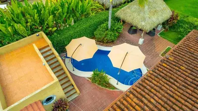 an overhead view of two umbrellas on a patio at Villa Felicidad by Vacation Pura Vida in Esterillos