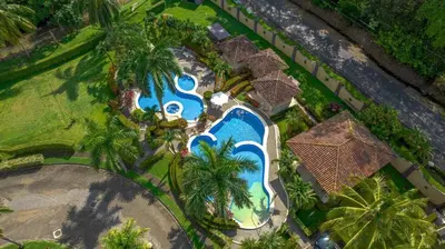 an overhead view of a swimming pool at a resort at Villa Felicidad by Vacation Pura Vida in Esterillos
