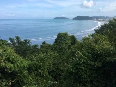 a view of a beach with trees and the ocean at Villa Escapadita by Vacation Pura Vida in Esterillos