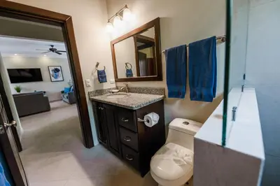 a bathroom with a toilet and a sink and a mirror at Casa 40 Villa Mario by Vacation Pura Vida in Bejuco
