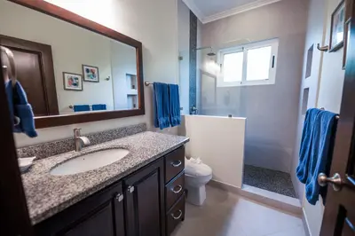 a bathroom with a sink and a toilet and a mirror at Casa 40 Villa Mario by Vacation Pura Vida in Bejuco