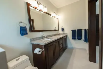a bathroom with a sink and a mirror and a toilet at Casa 40 Villa Mario by Vacation Pura Vida in Bejuco