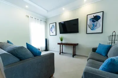 a living room with two couches and a tv at Casa 40 Villa Mario by Vacation Pura Vida in Bejuco