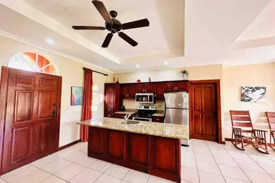 a kitchen with a ceiling fan and a counter top at Villa Tranquilidad by Vacation Pura Vida in Esterillos