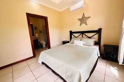 a bedroom with a bed and a star on the wall at Villa Tranquilidad by Vacation Pura Vida in Esterillos