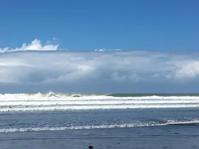 a person standing on the beach near the ocean at Villa Tranquilidad by Vacation Pura Vida in Esterillos