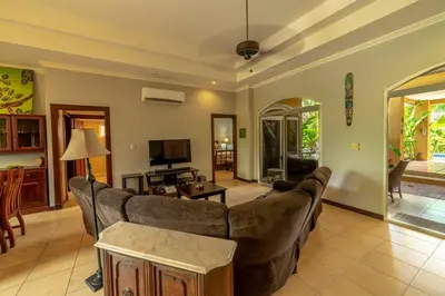 a living room with a couch and a table at Villa Estrella de Mar by Vacation Pura Vida in Bejuco