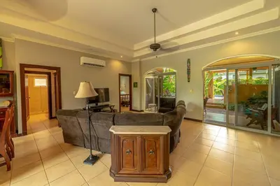 a living room with a couch and a table at Villa Estrella de Mar by Vacation Pura Vida in Bejuco