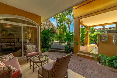 a living room with a couch and a table at Villa Estrella de Mar by Vacation Pura Vida in Bejuco