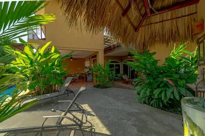 a patio with chairs and plants in a building at Villa Estrella de Mar by Vacation Pura Vida in Bejuco