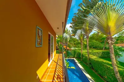 a house with a swimming pool and palm trees at Villa Estrella de Mar by Vacation Pura Vida in Bejuco