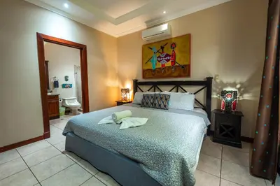 a bedroom with a bed with two towels on it at Villa Zen by Vacation Pura Vida in Esterillos