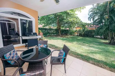 a patio with a table and chairs and a piano at Villa Zen by Vacation Pura Vida in Esterillos