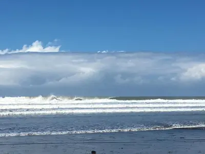 a person walking on the beach near the ocean at Villa Zen by Vacation Pura Vida in Esterillos
