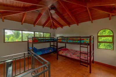 a room with three bunk beds in it at Villa Macaw by Vacation Pura Vida in Esterillos Este