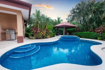 a swimming pool in the middle of a yard at Villa Sendero by VacationPuraVida in Bejuco