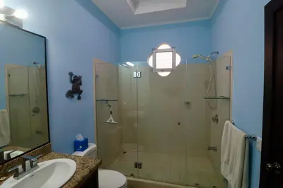 a bathroom with a shower and a toilet and a sink at Villa Sendero by VacationPuraVida in Bejuco