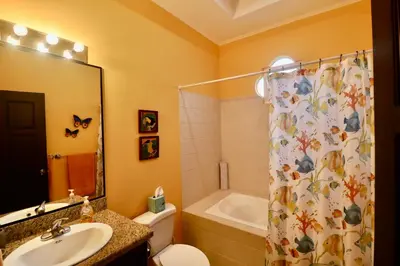 a bathroom with a toilet and a sink and a shower at Villa Sendero by VacationPuraVida in Bejuco