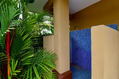 a bathroom with blue tiles and a green plant at Villa Sendero by VacationPuraVida in Bejuco