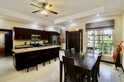 a kitchen and dining room with a table and chairs at Villa Sendero by VacationPuraVida in Bejuco