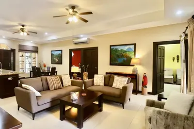 a living room with couches and a table at Villa Sendero by VacationPuraVida in Bejuco