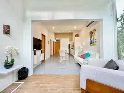 a living room with white walls and white furniture at Modern 2 Bed 2 Bath l Strong Wifi Carport in Jacó