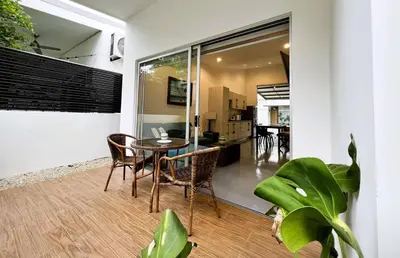 a dining room with a table and chairs in a house at Carport Strong Wifi Vaulted Ceilings in Jacó