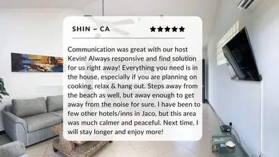 a sign in a living room with a couch and a tv at Spacious 2 Bed 2 Bath l Great Walking Score in Jacó