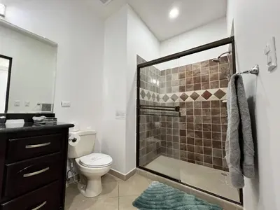 a bathroom with a shower with a toilet and a sink at Spacious 2 Bed 2 Bath l Great Walking Score in Jacó
