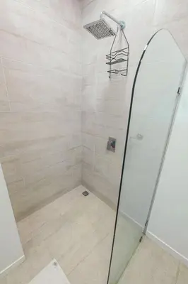 a bathroom with a shower with a glass door at Ocean Views l Steps to Beach l Sunset 305 in Jacó
