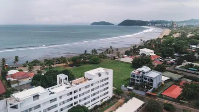 an aerial view of a beach and a building at Ocean Views l Steps to Beach l Sunset 305 in Jacó