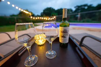 two wine glasses sitting on a table with a bottle of wine at Villa Alegría de vivir by Vacation Pura Vida in Bejuco