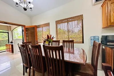 a dining room with a table and chairs at Villa Camino Corral by Vacation Pura Vida in Esterillos