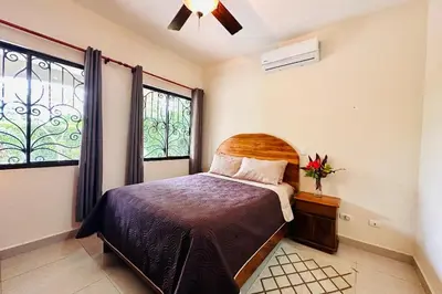 a bedroom with a bed and a window at Villa Camino Corral by Vacation Pura Vida in Esterillos