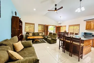 a living room with a couch and a table at Villa Camino Corral by Vacation Pura Vida in Esterillos