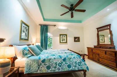 a bedroom with a bed and a ceiling fan at Villa Encanto by Vacation Pura Vida in Bejuco
