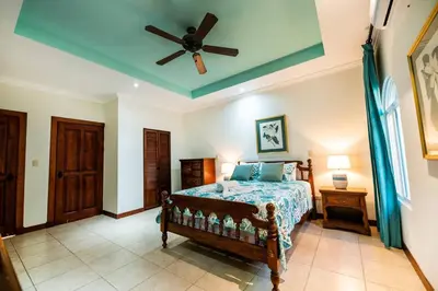a bedroom with a bed and a ceiling fan at Villa Encanto by Vacation Pura Vida in Bejuco
