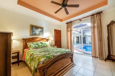 a bedroom with a bed and a ceiling fan at Villa Encanto by Vacation Pura Vida in Bejuco