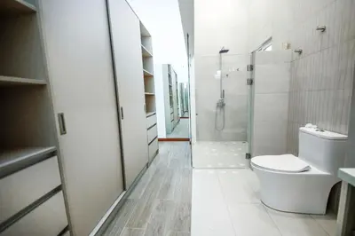 a white bathroom with a toilet and a shower at Villa Luna Nueva by Vacation Pura Vida in Esterillos