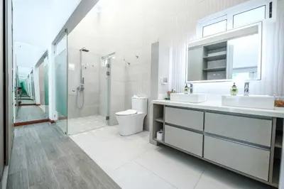 a bathroom with two sinks and a shower and a toilet at Villa Luna Nueva by Vacation Pura Vida in Esterillos